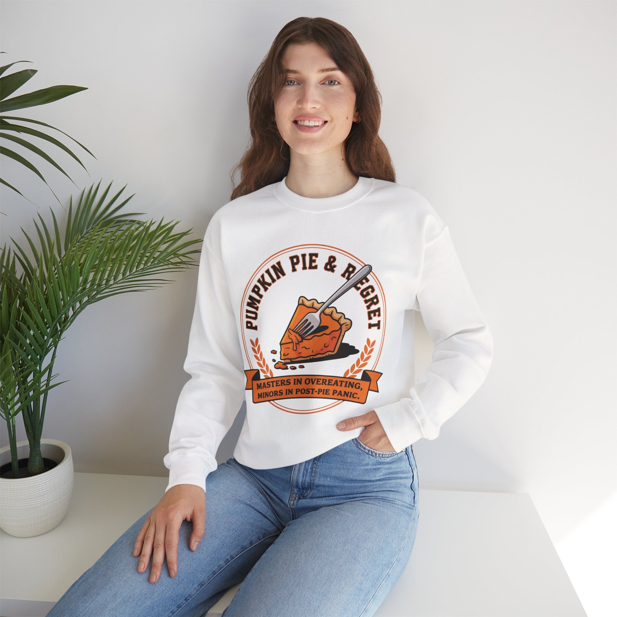Person wearing a White sweatshirt with a pumpkin pie graphic and text.